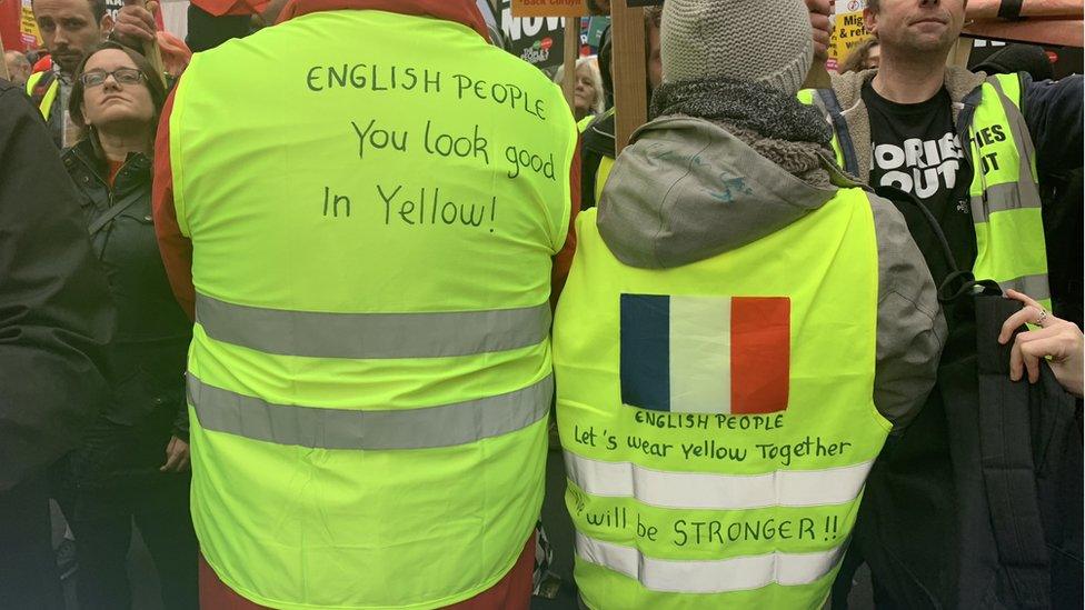 Erick Simon and Laurie Martin showing their yellow jackets