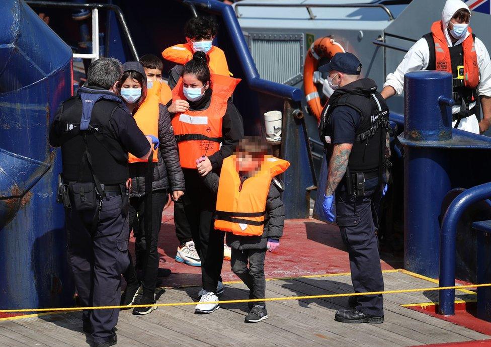 A group of migrants, including children, are brought to Dover on Thursday 3 June