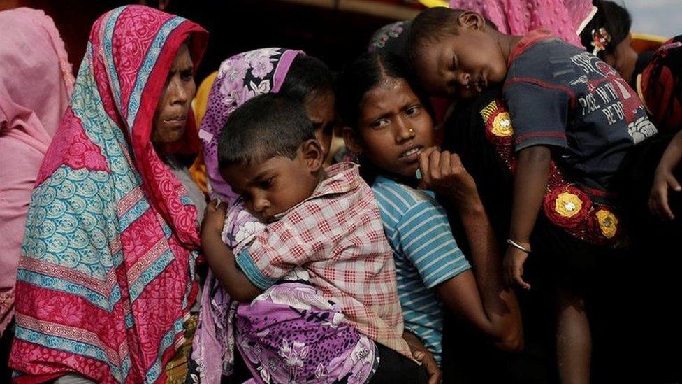 Rohingya refugees line up for a food supply distribution at the Kutupalong refugee camp near Cox's Bazar, Bangladesh 12 December 2017.