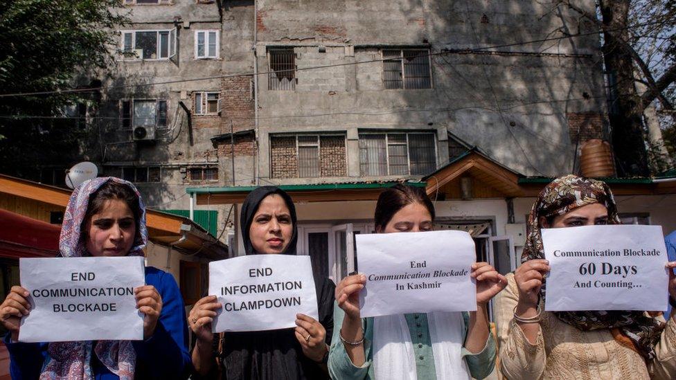 Kashmiri women journalists hold placards as they protest against the continued communication blockade by the Indian authorities after the revocation of special status of Kashmir on October 03 , 2019 in Srinagar.