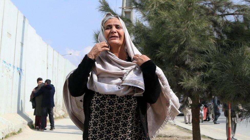 An Afghan woman cries as her family member stuck in the Sardar Daud Khan"s Hospital, also known as Kabul Military Hospital, during an attack by suspected militants in Kabul