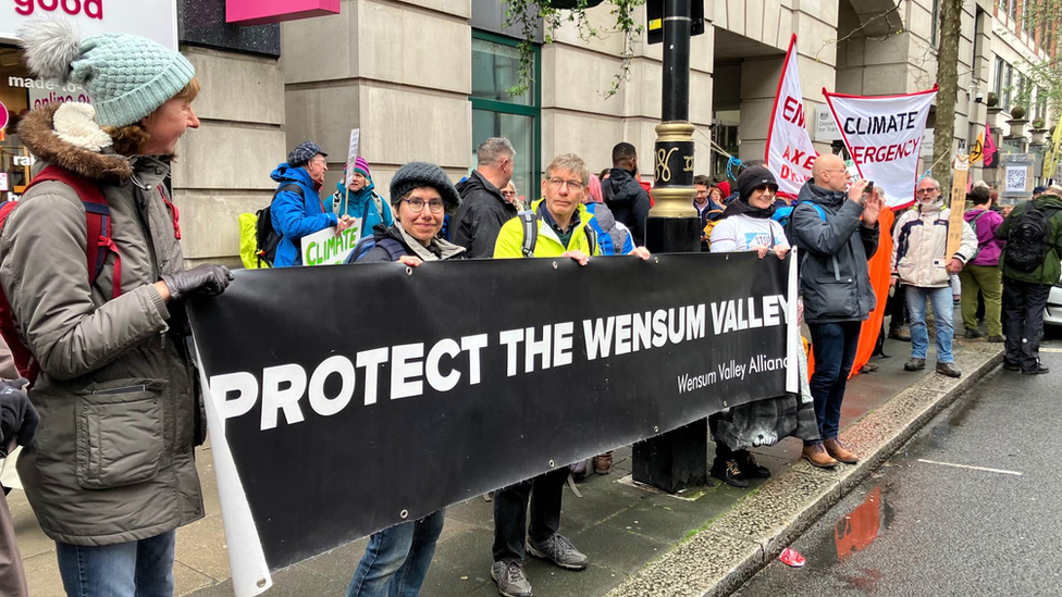 Protestors holding up sign which reads Protect the Wensum Valley