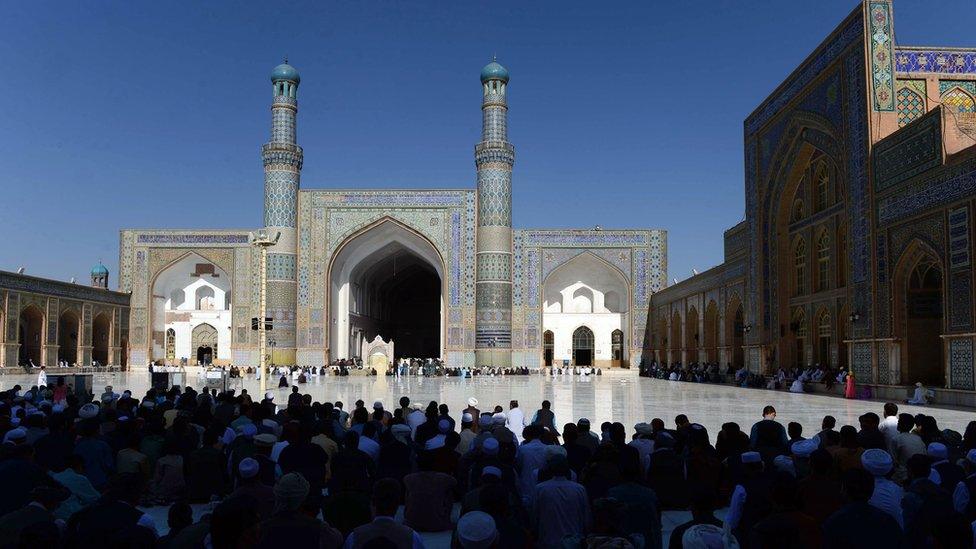 Afghan devotees offer prayers at the start of the Eid al-Fitr holiday which marks the end of Ramadan at the Jamee (mosque) in Herat on July 17, 2015