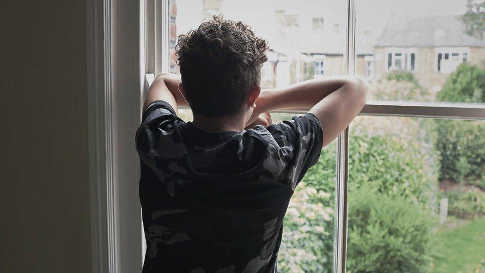 Boy looking out of window