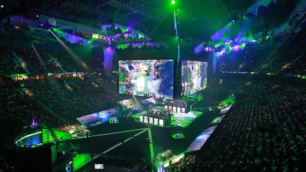 Members of PSG.LGD and OG sit in their booths as they play in their grand final Dota 2 match on Day 6 of The International 2018 at Rogers Arena on August 25, 2018 in Vancouver, Canada.