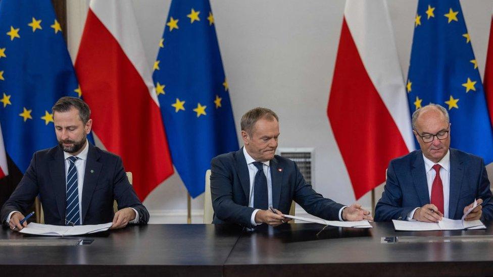 Leaders of the Polish liberal opposition parties (L-R) Wladyslaw Kosiniak Kamysz of the Third Way party, Donald Tusk of the Civic Coalition, and Wlodzimierz Czarzasty of the Left party sign the coalition deal,