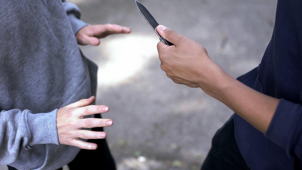 A teenager with a knife