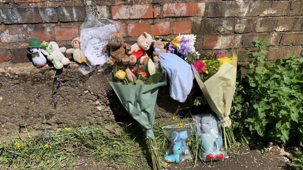 Tributes left on a nearby footbridge