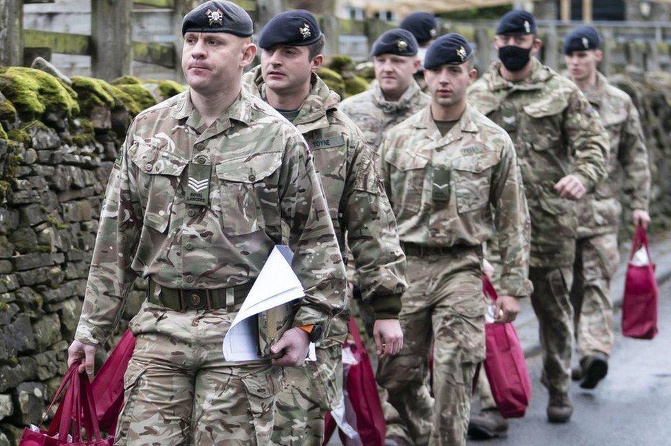 Soldiers delivering supply packages