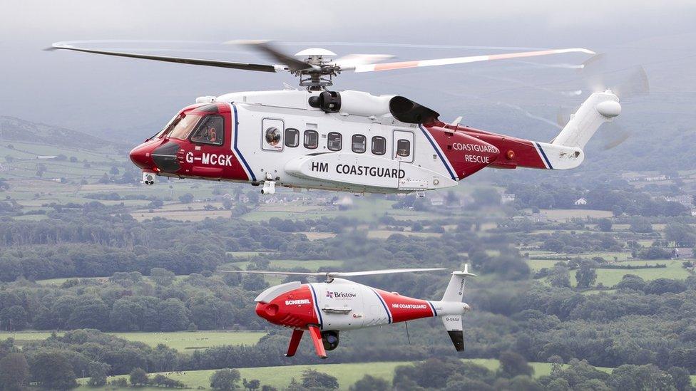 The Sikorsky S92 Bristow HM Coastguard search and rescue helicopter flying with a HM Coastguard Schiebel Camcopter S-100