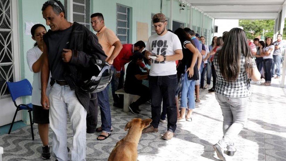 A health agent vaccinates people during a campaign of vaccination against yellow fever in Mairipora, Brazil January 10, 2018.