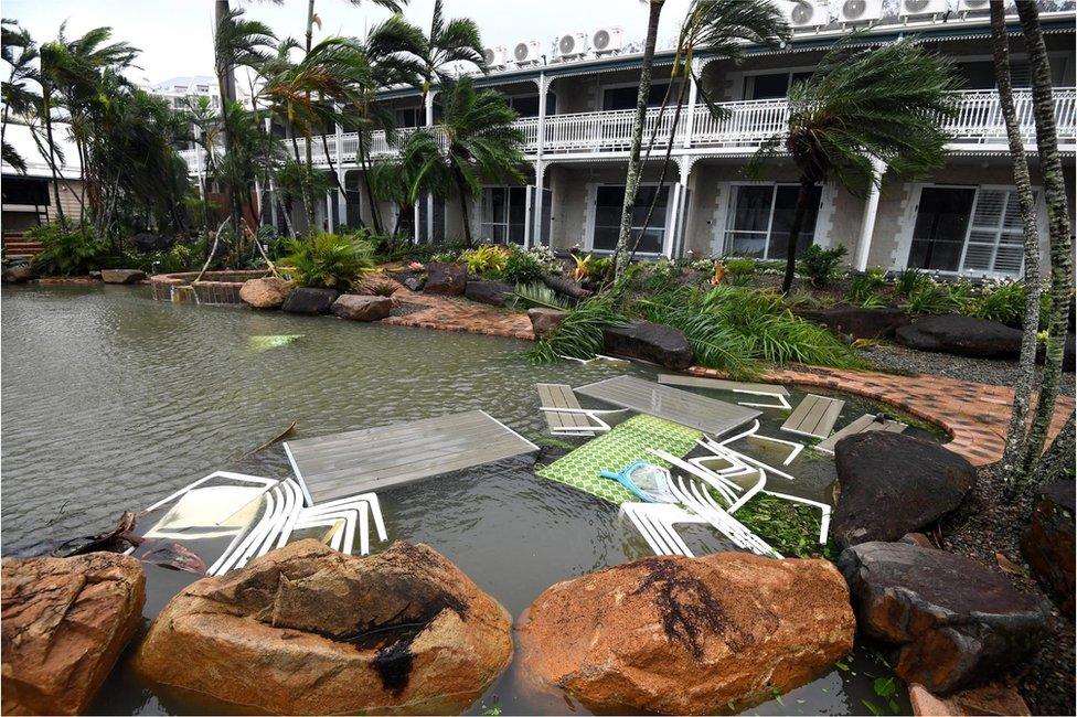 Outdoor furniture floats in a pool, placed for safety, at a motel at Airlie Beach, Queensland, Australia, 28 March 2017