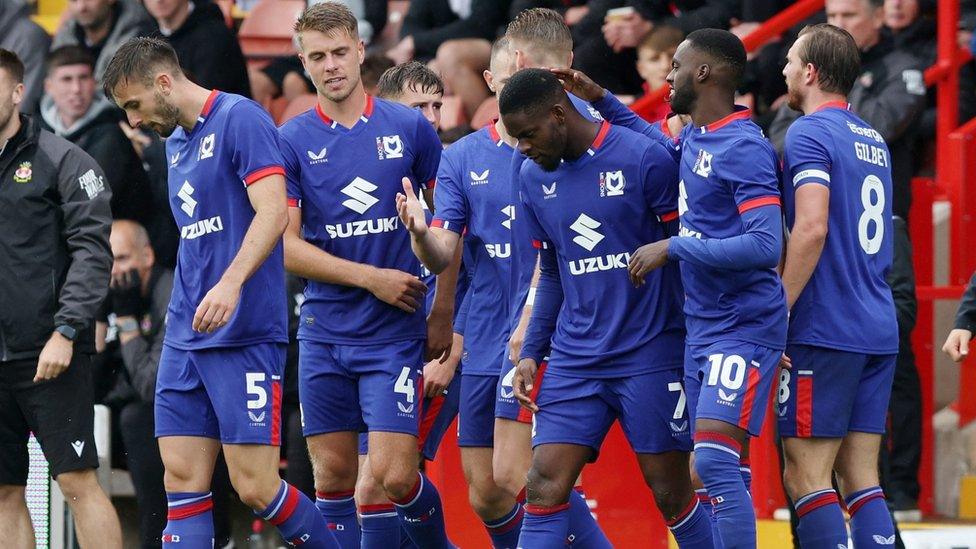 MK Dons players celebrate Jonaathan Leko's goal