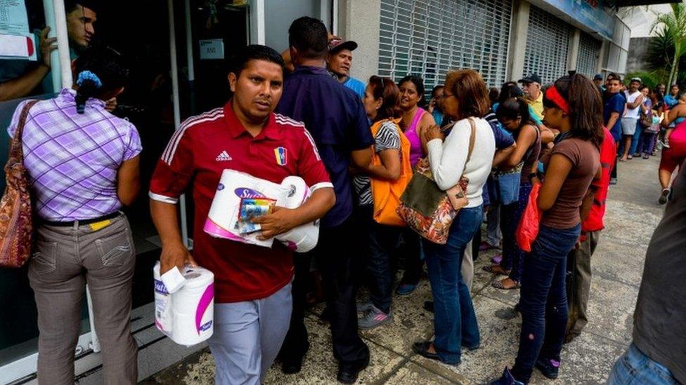 Long queue outside supermarket in Caracas