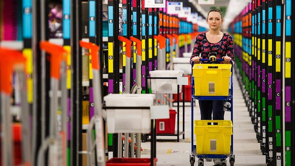 Woman in Amazon delivery warehouse