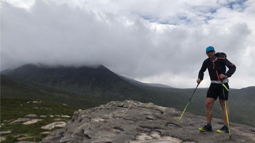 Ross standing on a mountain top