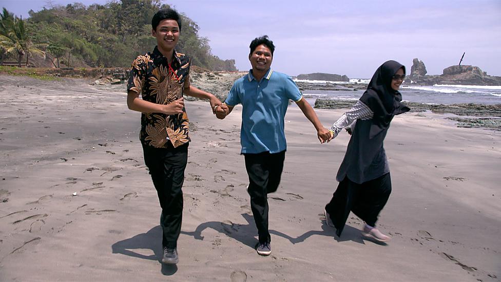 the family running on the beach