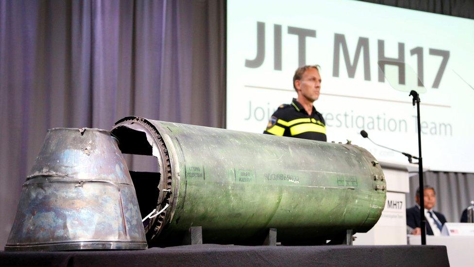 A damaged missile is displayed during a news conference by members of the Joint Investigation Team, comprising the authorities from Australia, Belgium, Malaysia, the Netherlands and Ukraine who present interim results in the ongoing investigation of the 2014 MH17