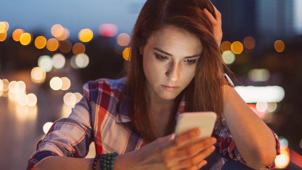 Woman looks at phone