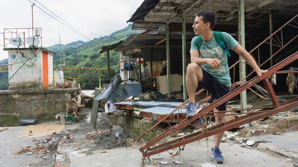 A man stands by the ruins of a building near Ituango in Colombia