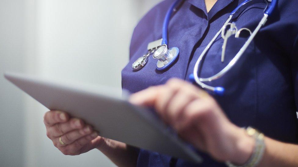 Stock image of a nurse using a tablet