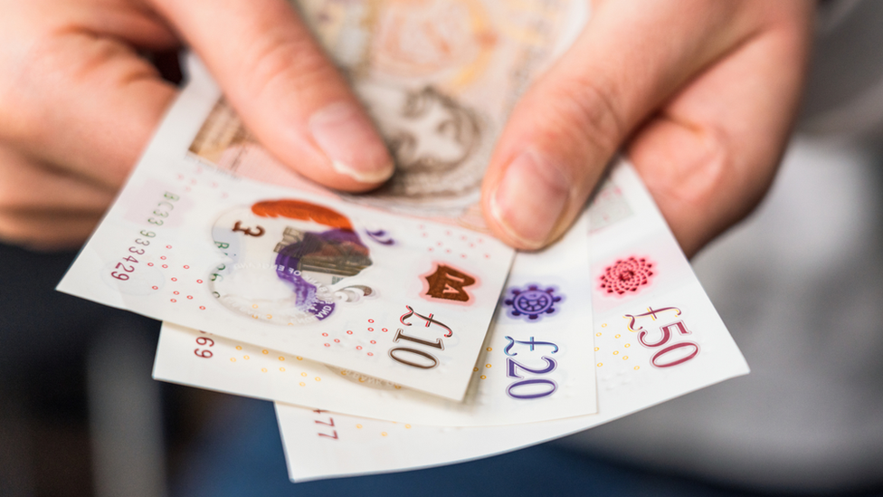 Person holds polymer bank notes