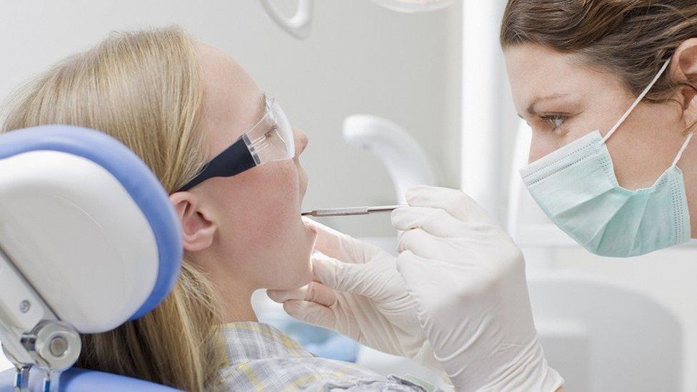 Dental hygienist examining a patient