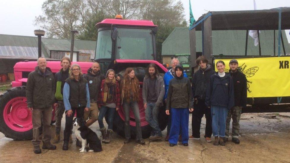 Members of Extinction Rebellion in front of the pink tractor they have been taking to demonstrations