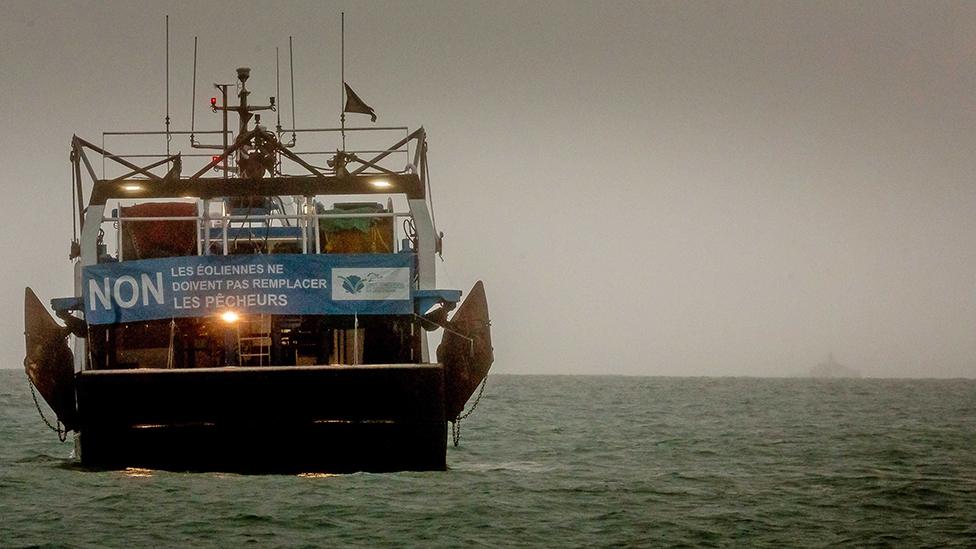 A French fishing boat with a protest sign opposing new fishing licenses on May 6, 2021 in St Helier, Jersey.