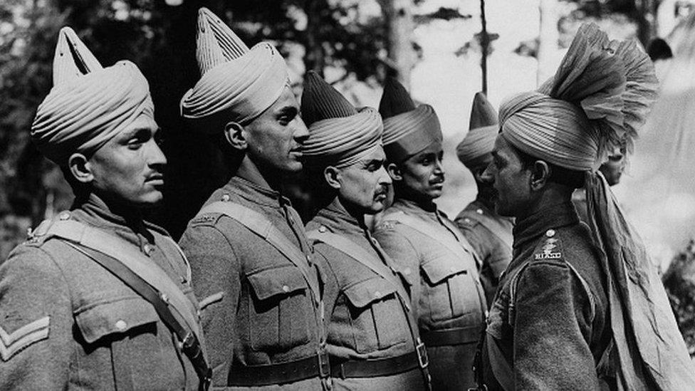 Types Of Indian Soldiers Being Inspected By Their Officer. This series of pictures were taken of the B.E.F Indian troops "somewhere in England"; many of them have just arrived back from Dunkirk under the charge of Major Wainwright and Major Jermyn, two British officers. (