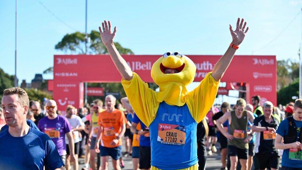 man in Sesame Street costume runs