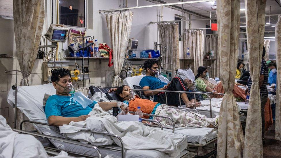 Patients who contracted the coronavirus lie in beds while connected to oxygen supplies inside the emergency ward of a Covid-19 hospital on May 03, 2021 in New Delhi, India.