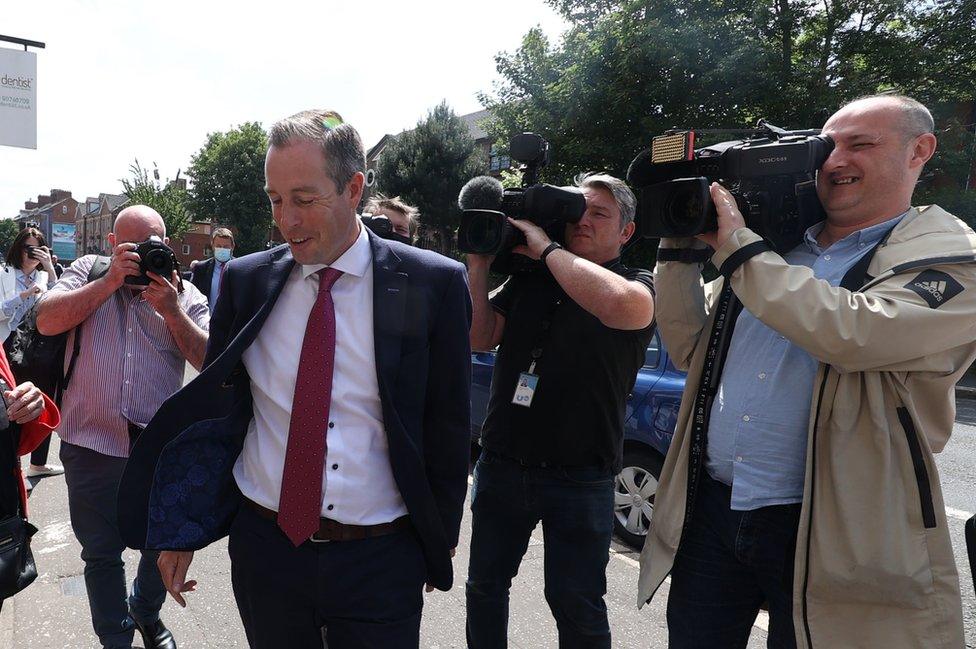 TV camera operators follow First Minister Paul Givan during an appointment in Belfast