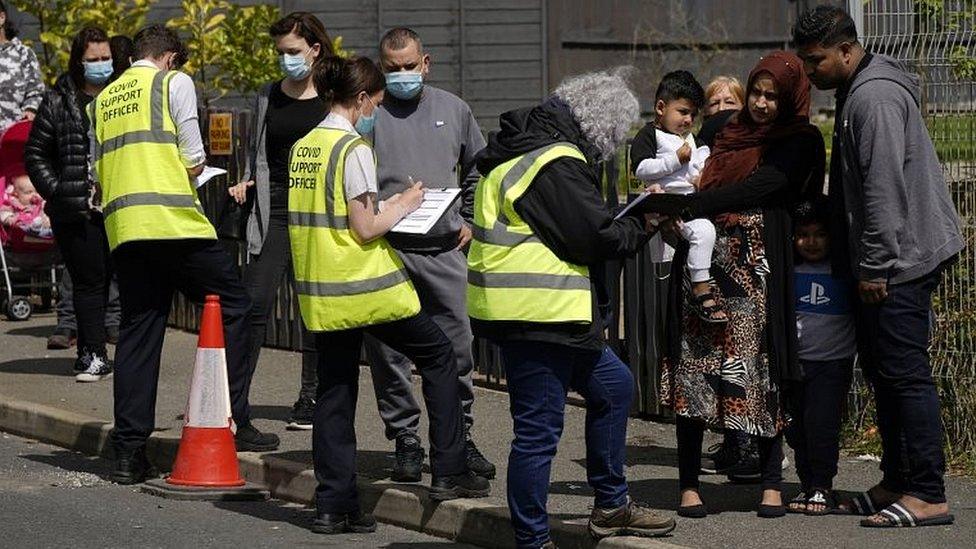 People queuing to get a vaccine in Bolton