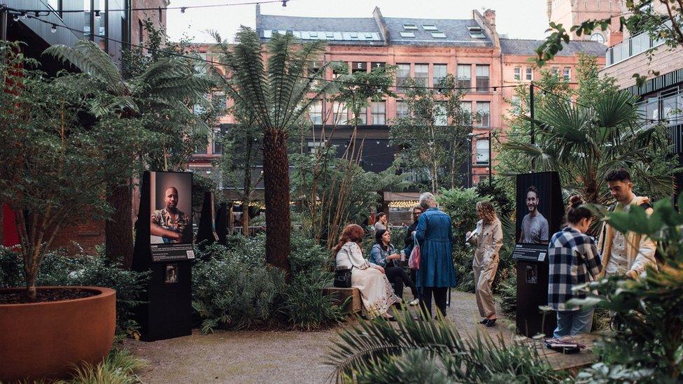 People at a open air exhibition in the Kampus garden near Canal Street