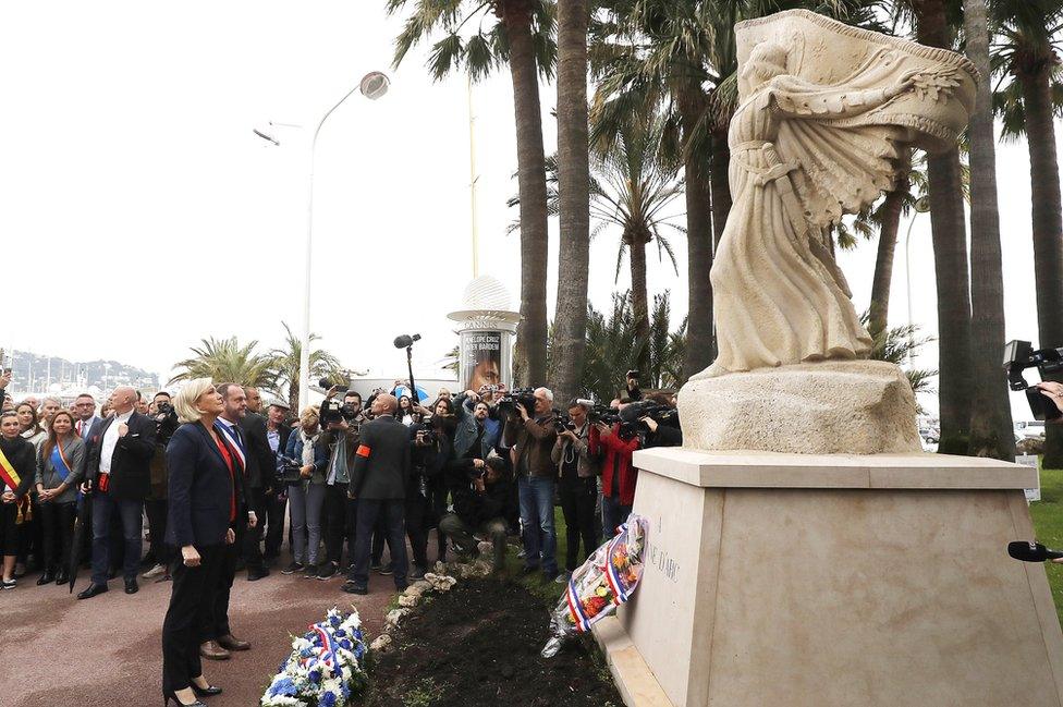 French far-right political party National Front (FN) leader Marine Le Pen (L) lays a wreath at the statue of Joan of Arc during the party's traditional May Day in Cannes, southern France, 01 May 2018.