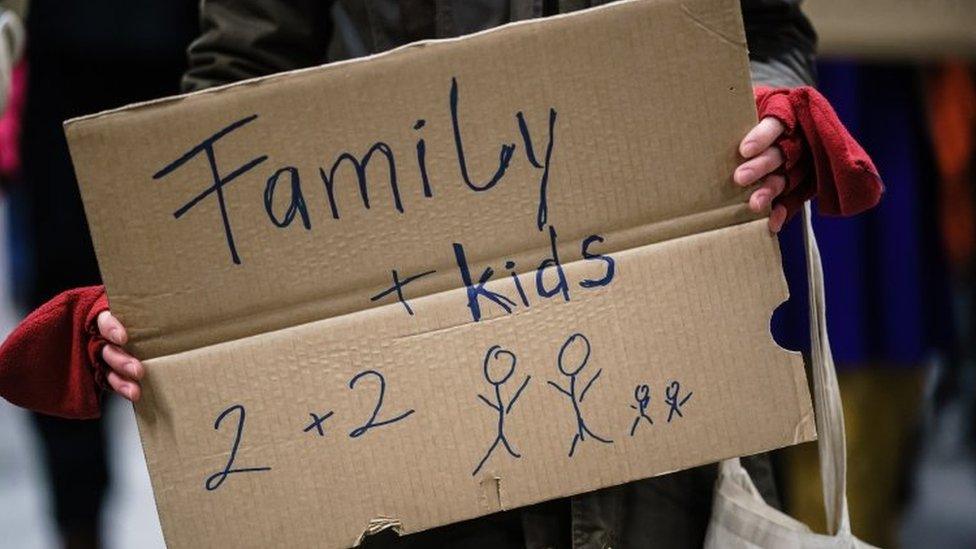 A sign on cardboard that says family + kids