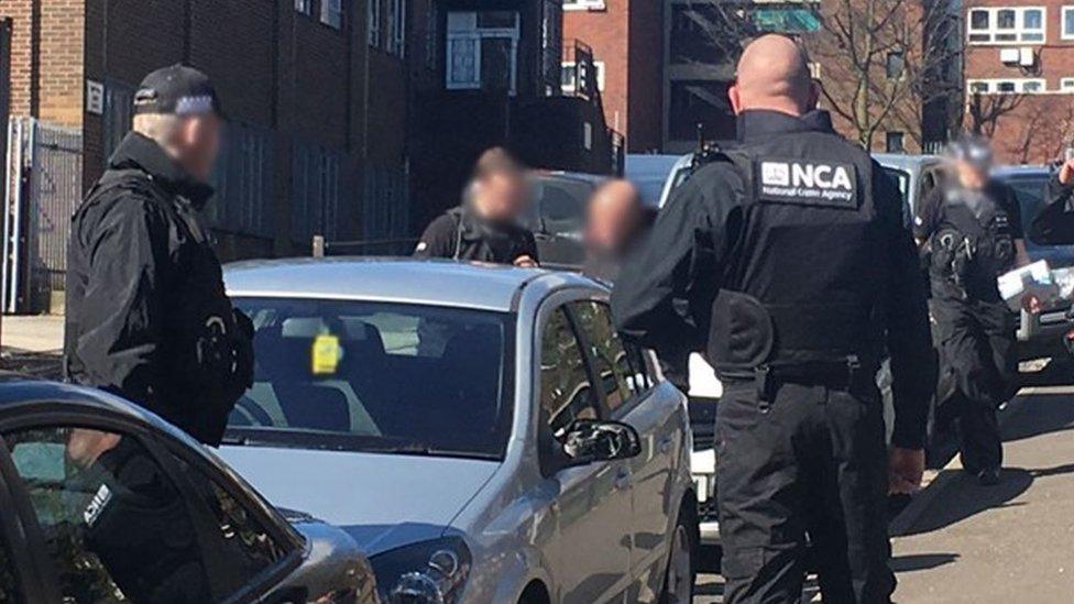 NCA officers searching a car in Oldham