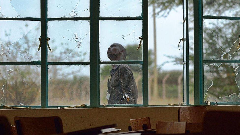 A man walks past bullet-shattered windows at Garissa University (file photo)