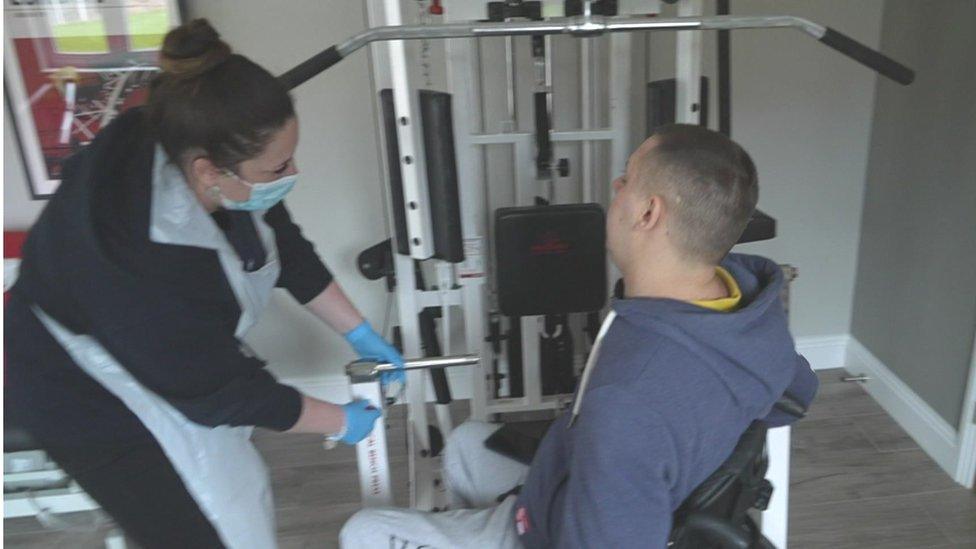 Steve using gym equipment with help from carer Jazzmine Mace