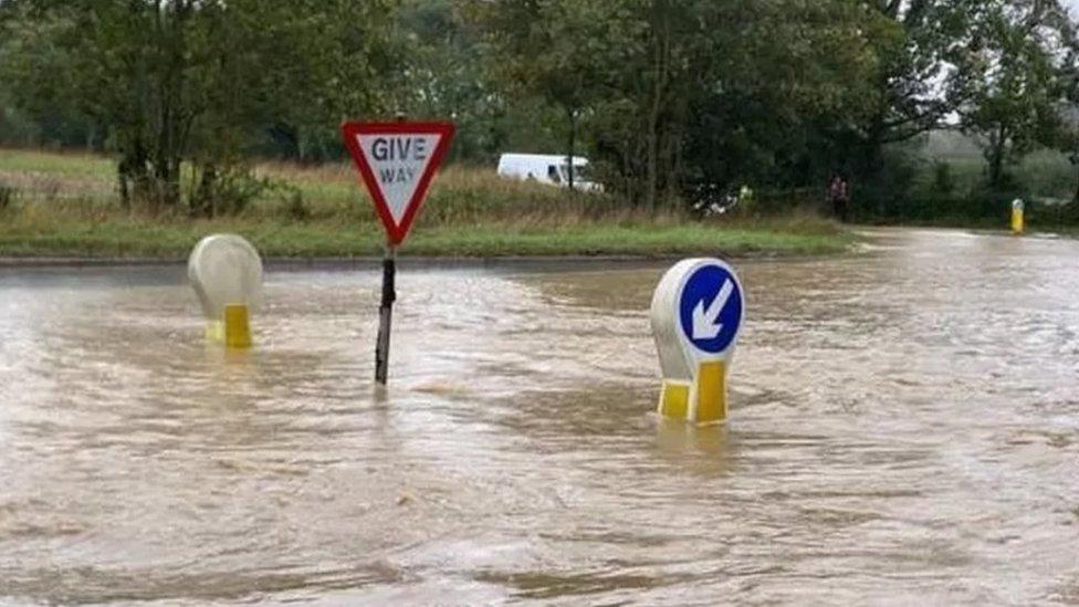 High flood waters around street signs