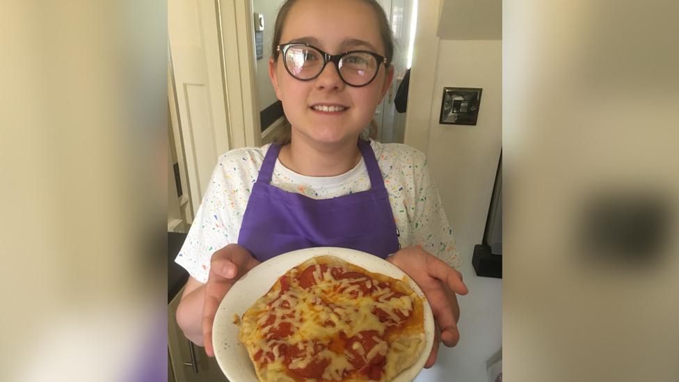 Megan making a pizza