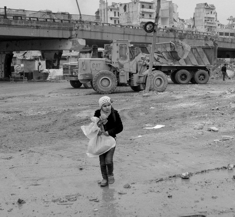 Child carries a bag in eastern Aleppo