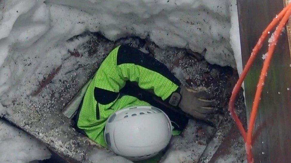 A handout photo made available on 24 January 2017 by the Italian Fire Department (Vigili del Fuoco) shows a firefighter searching through the debris of the Hotel Rigopiano in Farindola, Abruzzo region, Italy