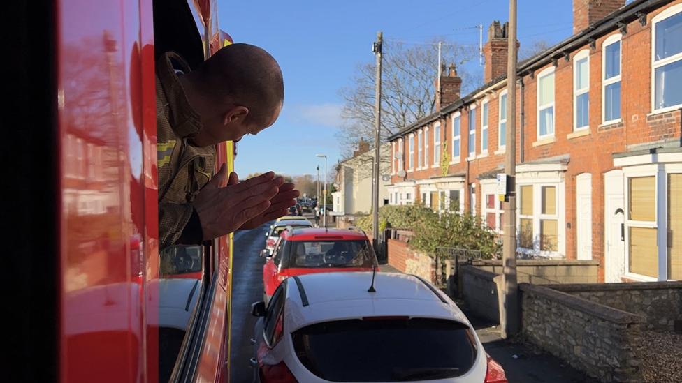 Firefighter checking parked cars