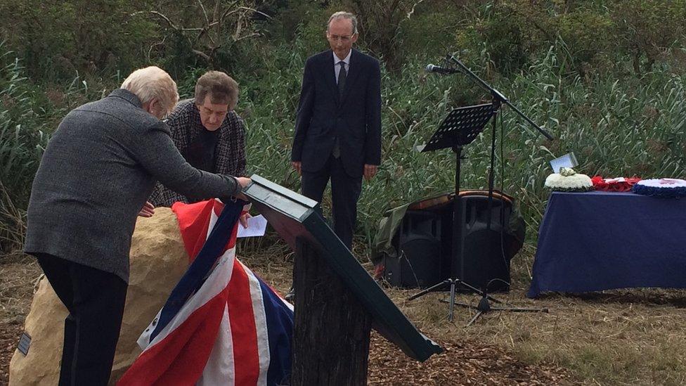 Relatives of Harold Penketh unveil his memorial stone which had a Union Flag draped over it.