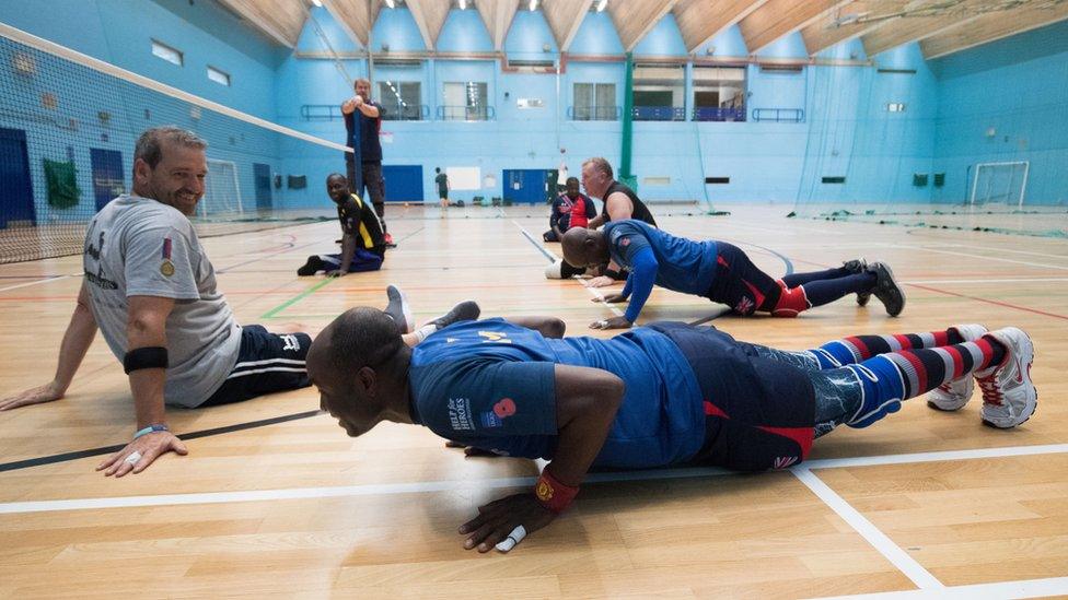 Athletes Daniel Kitcher and Frank Aveh doing press-ups