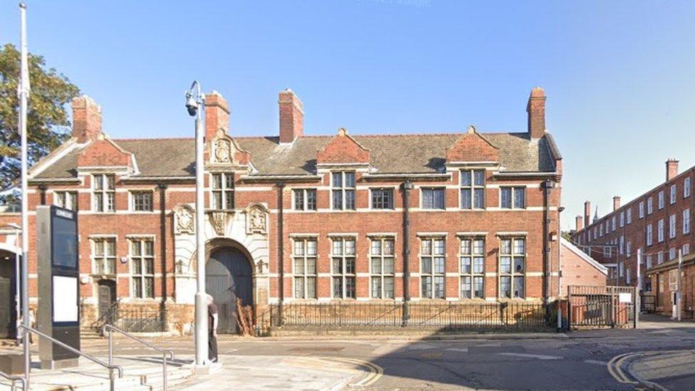 Two-storey brick biulding with stone gateway