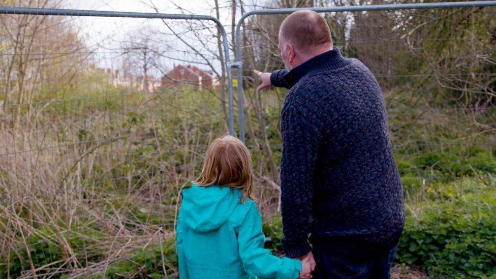 Man and girl looking at the site in Greenfields, Shrewsbury