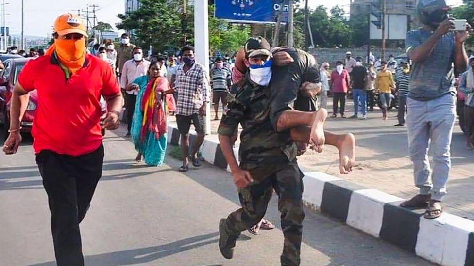 Rescuers evacuate people following a gas leak incident at an LG Polymers plant in Visakhapatnam on May 7, 2020